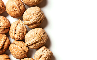 Walnuts on a white background top view. Free space for text. Soft focus. Stylish food background with nuts.