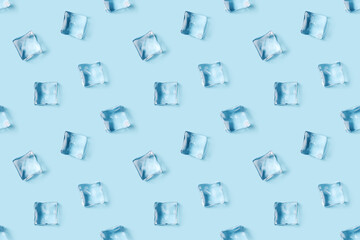 Seamless pattern of scattered ice cubes on blue background, top view.