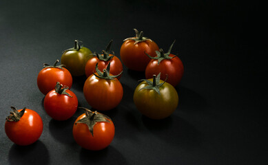 cherry tomatoes on black background