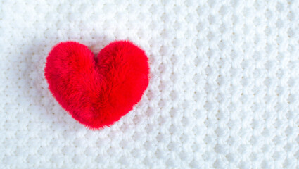 red soft heart on soft white fabric. A symbol of a healthy person. Valentine's Day gift