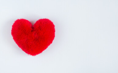 red soft heart on soft white background. A symbol of a healthy person. Valentine's Day gift