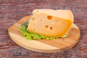 Maasdam cheese  in the board served salad leaves