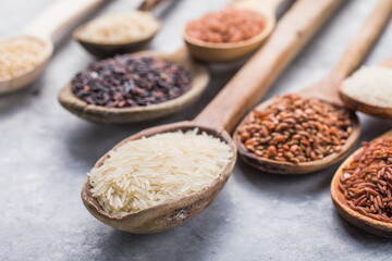 Organic white Jasmine rice, unpolished black and brown rice, Riceberry  in wooden spoons