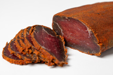 Jerky on a white background. Close-up of Armenian basturma sliced into pieces.