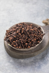Spice dry cloves on  stone background with copy space