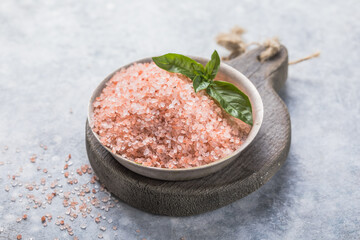 Himalayan pink salt crystals with white salt on wooden spoon, scrub spa therapy, cooking healthy...