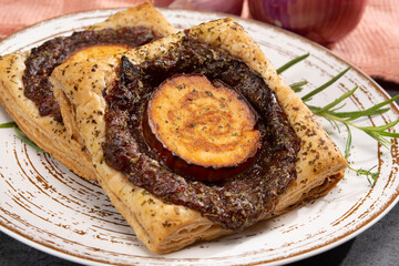 Fresh baked puff tarts with caramelized onion and goat cheese