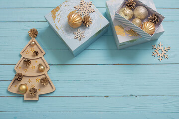 Christmas gifts with golden decorations on blue wooden background