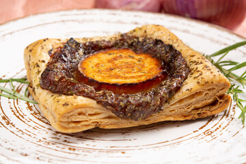 Fresh baked puff tarts with caramelized onion and goat cheese