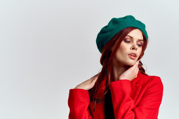 Woman in red coat and in green hat on isolated background cropped model with Copy Space emotions