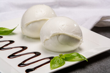 Сheese collection, balls on soft white mozzarella bufala cheese served with balsamic cream tomato and fresh basil white mozzarella bufala cheese served with balsamic cream and fresh basil