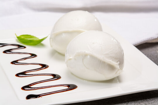 Сheese collection, balls on soft white mozzarella bufala cheese served with balsamic cream tomato and fresh basil white mozzarella bufala cheese served with balsamic cream and fresh basil