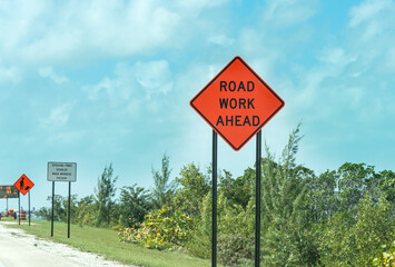 Road work ahead sign on the edge of the road