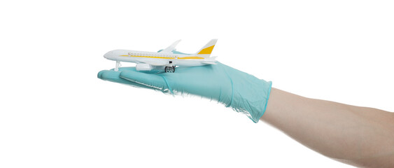 Hand in glove holding model airplanes on white background. Concept traveling. Copy space. © Object Studio