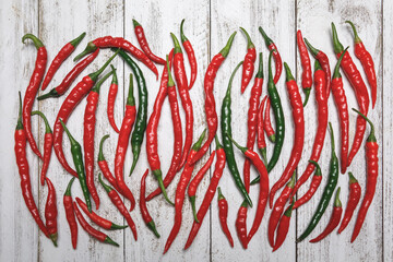 Top view of a group of fresh, organically grown, red and green cayenne peppers
