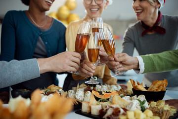 Close-up of business colleagues toasting with Champagne on New Year's party in the office.