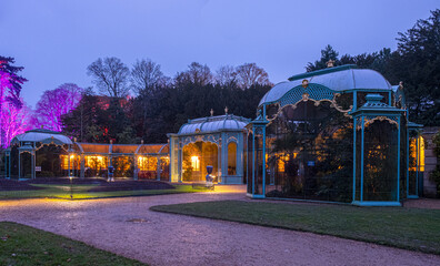 Obraz premium The aviary at Waddesdon Manor illuminated for Christmas.
