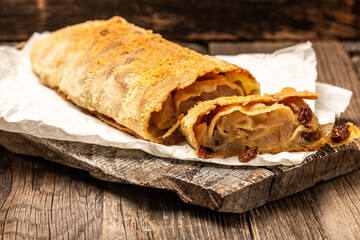 homemade apfelstrudel, Apple strudel with raisins and mint on light background. view from above, Food recipe background, austrian germany food