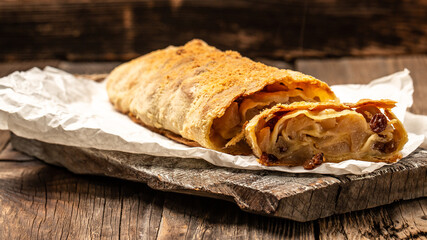 Strudel or apple pie on wooden board. Christmas homemade pastry. austrian germany food