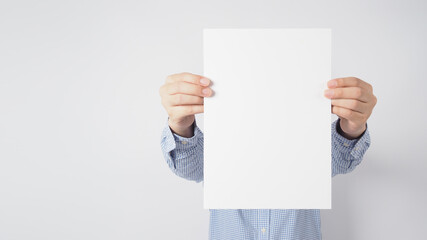 Male wear long sleeve shirt and hand is holding the blank paper on white background.Empty space for text.