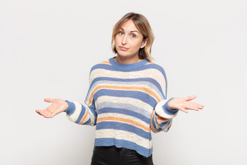 young pretty woman feeling puzzled and confused, unsure about the correct answer or decision,...