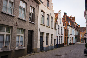 Fototapeta na wymiar Bruges, Belgium - May 12, 2018: Unique Street With Medieval Houses