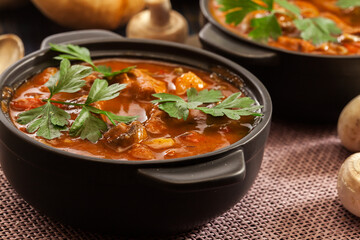 Stew soup with meat, potatoes, mushrooms and red pepper