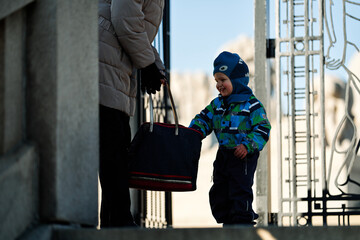 The grandson knows his grandmother carries goodies in her purse.