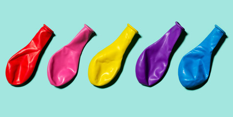 Colorful balloon flat lay on the pastel turquoise background. Horizontal banner of colorful balloons. Image for package or banner