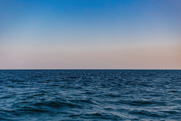 Sea walk on a boat overlooking the sunset in the sea.