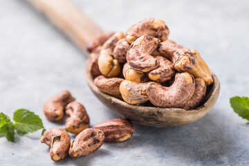 Cashew nuts in spoon top view. Healthy roasted nuts of cashew fruit