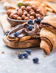 Continental breakfast with croissant, hazelnut chocolate spread and coffee.