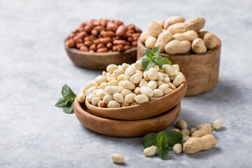 Raw dried fresh peanut nuts on a stone background