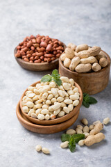 Raw dried fresh peanut nuts on a stone background