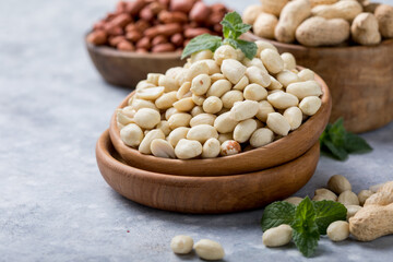 Raw dried fresh peanut nuts on a stone background