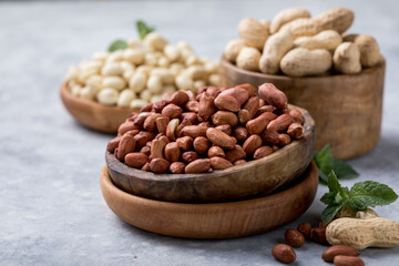 Raw dried fresh peanut nuts on a stone background