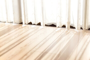 Obraz na płótnie Canvas レースカーテン越しの日光があたる床のテクスチャイメージ