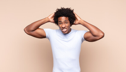 young black afro man looking puzzled, confused and stressed, wondering between different options,...