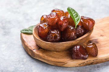 Dates or dattes palm fruit in wooden bowl is snack healthy.