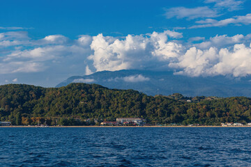 View of the sea coast with the city, mountains from the boat.