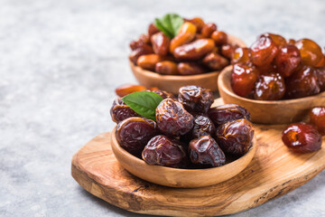 Dates or dattes palm fruit in wooden bowl is snack healthy.