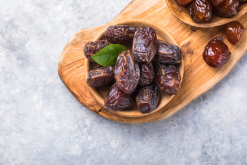 Dates or dattes palm fruit in wooden bowl is snack healthy.