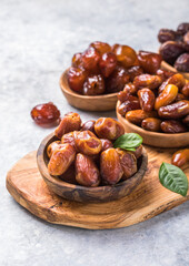 Dates or dattes palm fruit in wooden bowl is snack healthy.