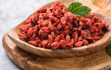 Goji in bowl on stone table.
