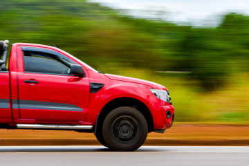 Red pick up on the highway
