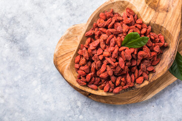 Goji in bowl on stone table.