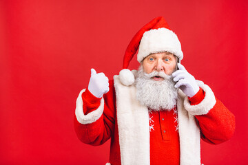 Portrait of nice attractive handsome amazed Santa using phone gadget 5g fast speed blog blogger browsing multimedia isolated over red background.