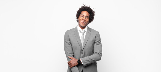black afro businessmanlaughing shyly and cheerfully, with a friendly and positive but insecure...