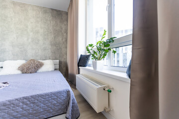 Big comfortable double bed in elegant classic bedroom