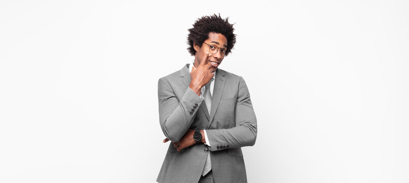 black afro businessmankeeping an eye on you, not trusting, watching and staying alert and vigilant